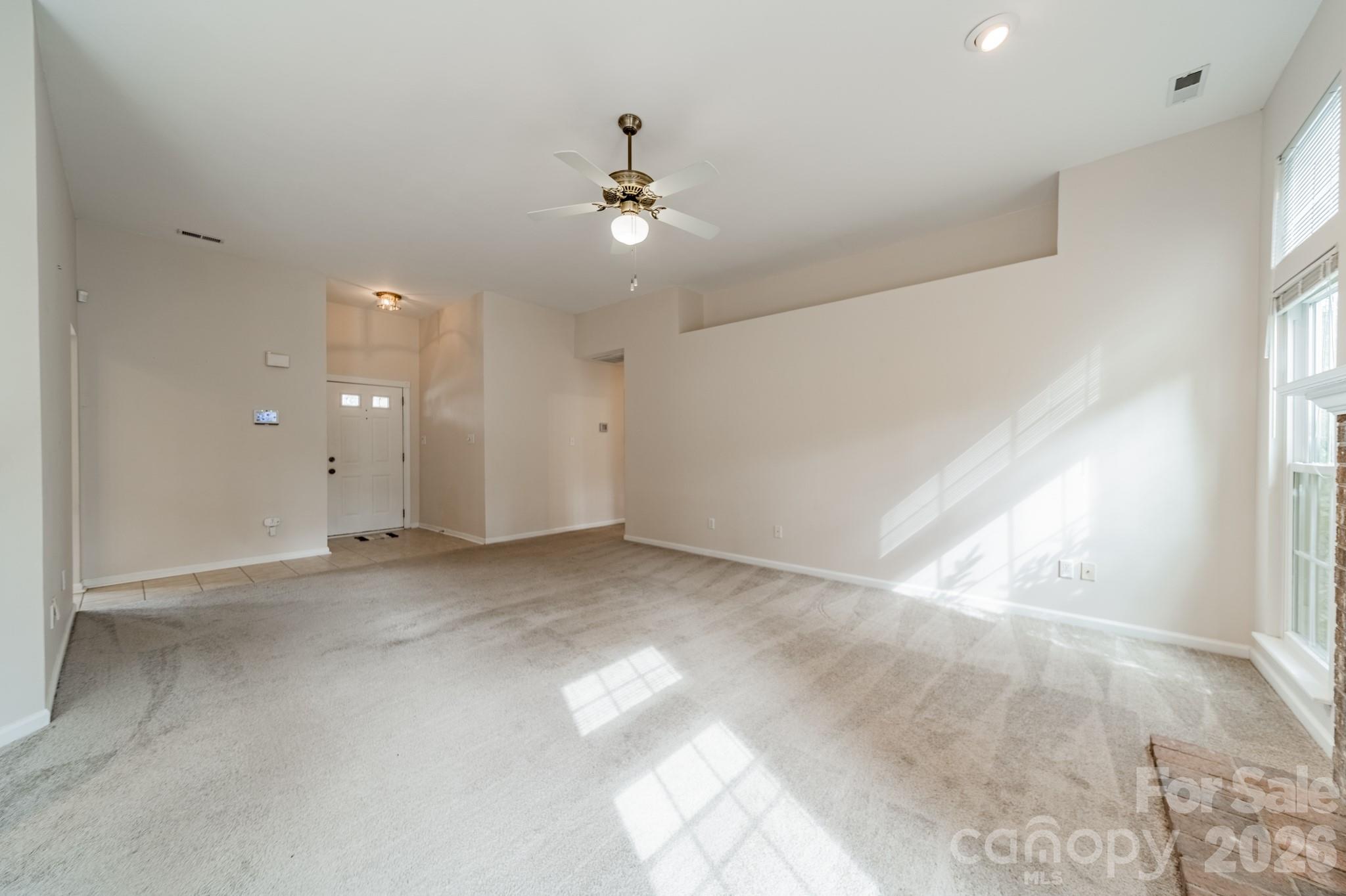 9409 Cedar River Road Huntersville, NC 28078 - Photo 12 of 31 wooden floor in an empty room with a window