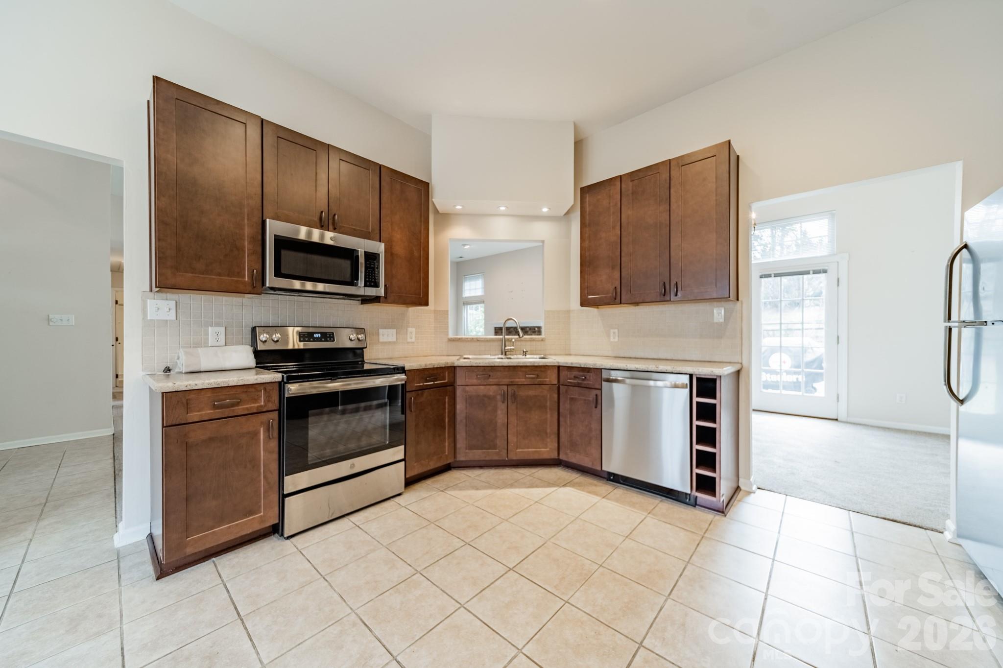 9409 Cedar River Road Huntersville, NC 28078 - Photo 15 of 31 a kitchen with stainless steel appliances cabinets a sink and a stove
