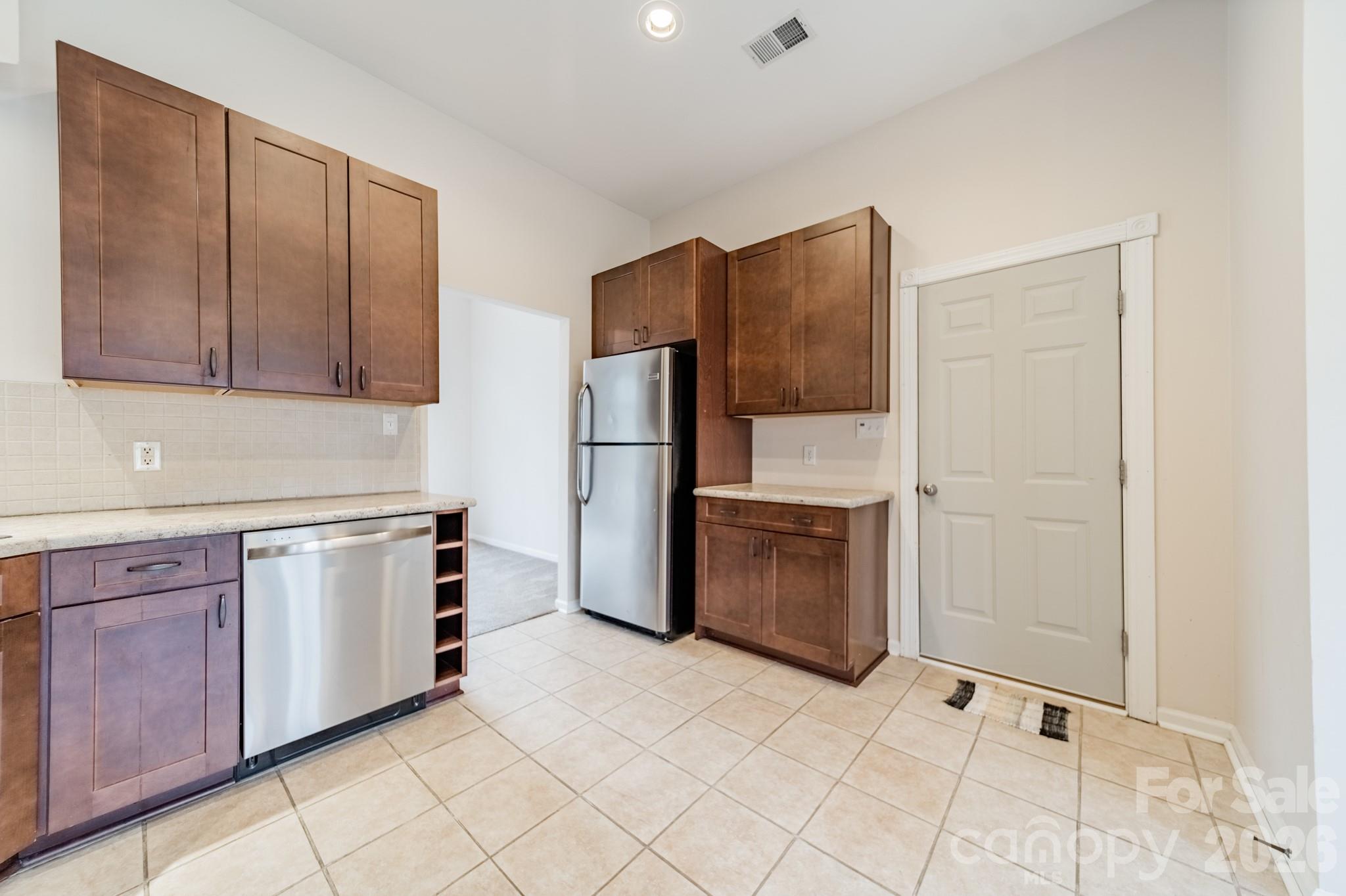 9409 Cedar River Road Huntersville, NC 28078 - Photo 18 of 31 a kitchen with stainless steel appliances granite countertop a refrigerator and a stove top oven