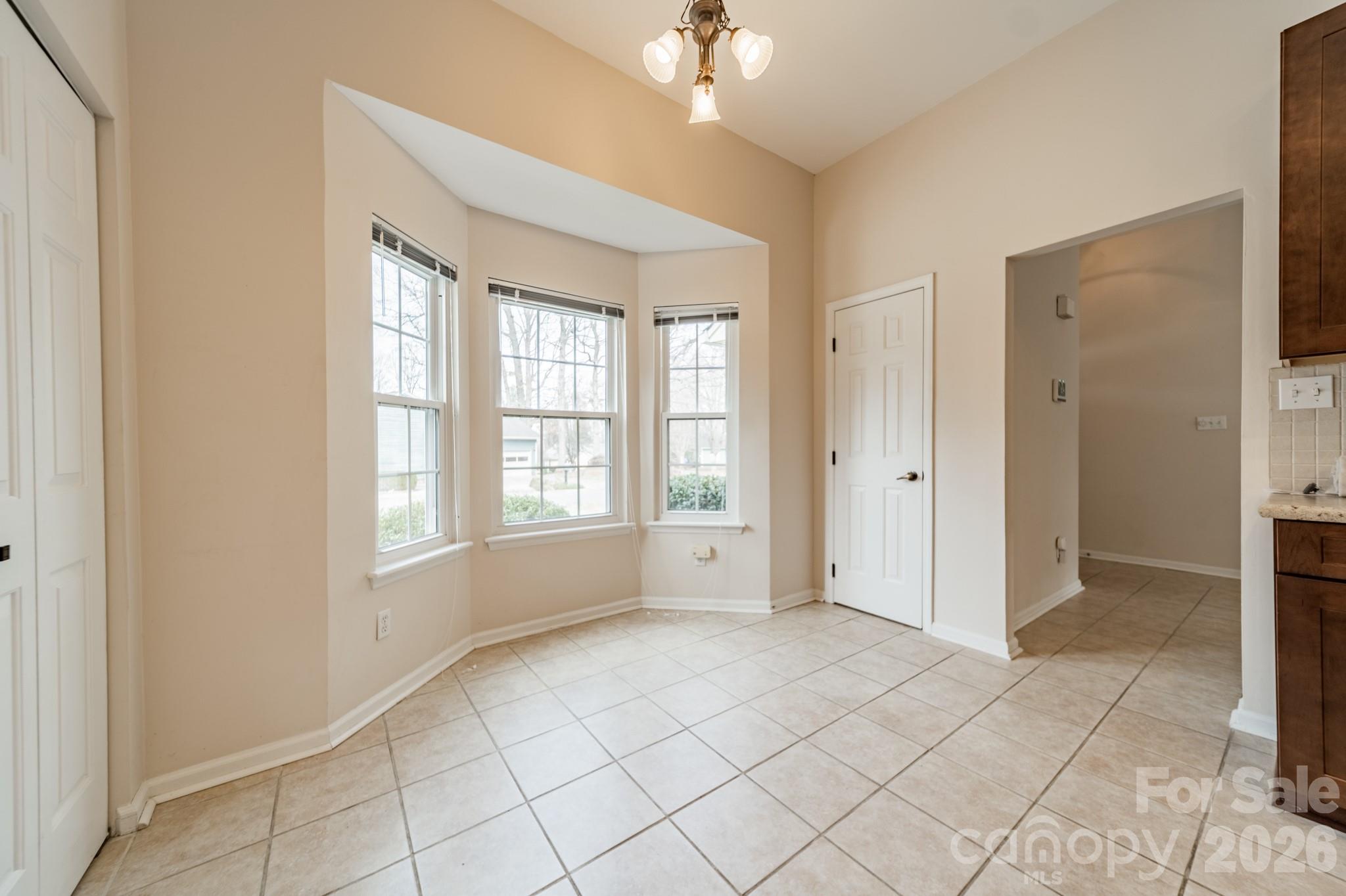 9409 Cedar River Road Huntersville, NC 28078 - Photo 20 of 31 a view of an empty room with window and chandelier fan