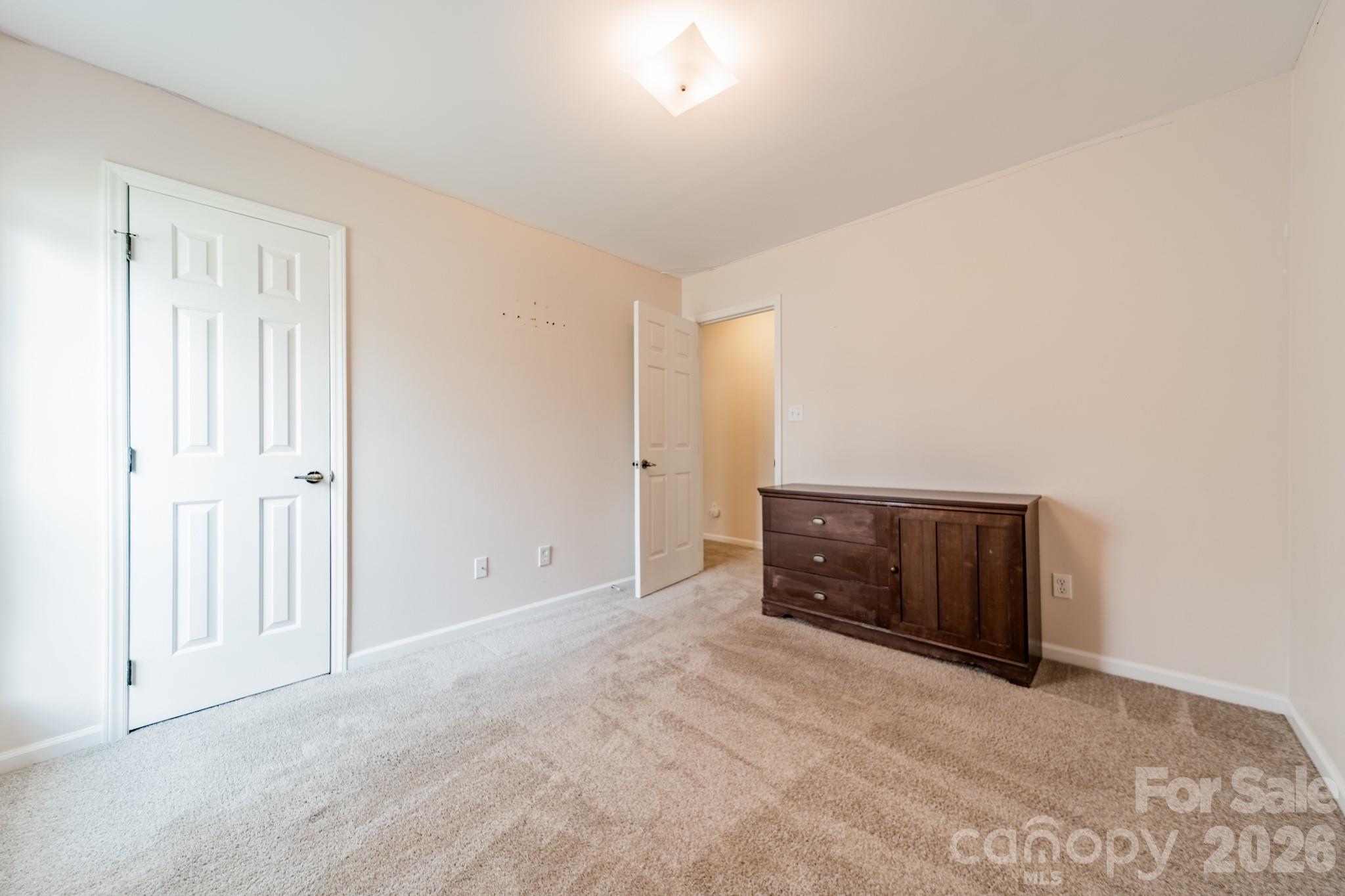 9409 Cedar River Road Huntersville, NC 28078 - Photo 22 of 31 an empty room with wooden floor and cabinet