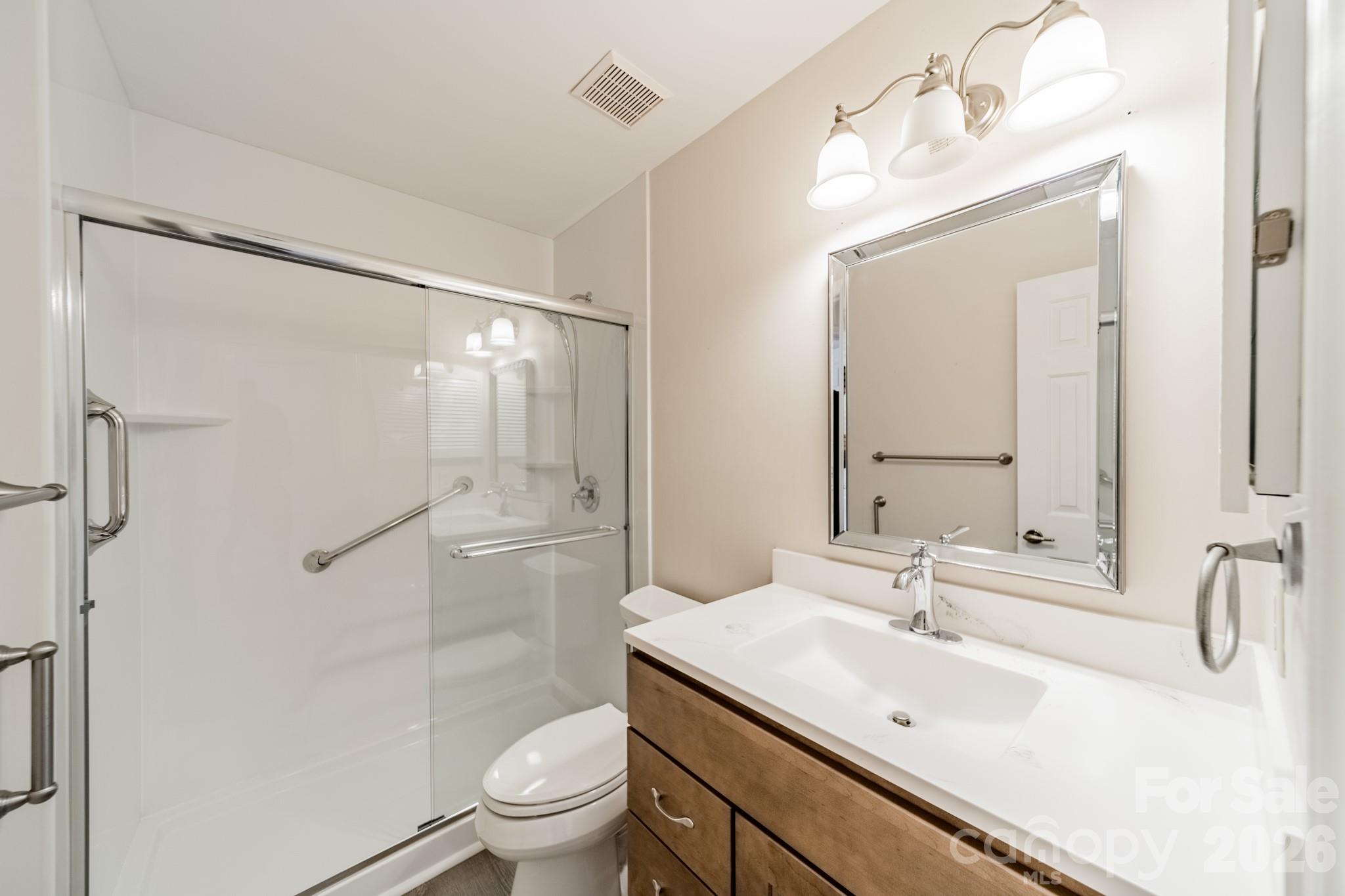 9409 Cedar River Road Huntersville, NC 28078 - Photo 25 of 31 a bathroom with a sink toilet double vanity and shower