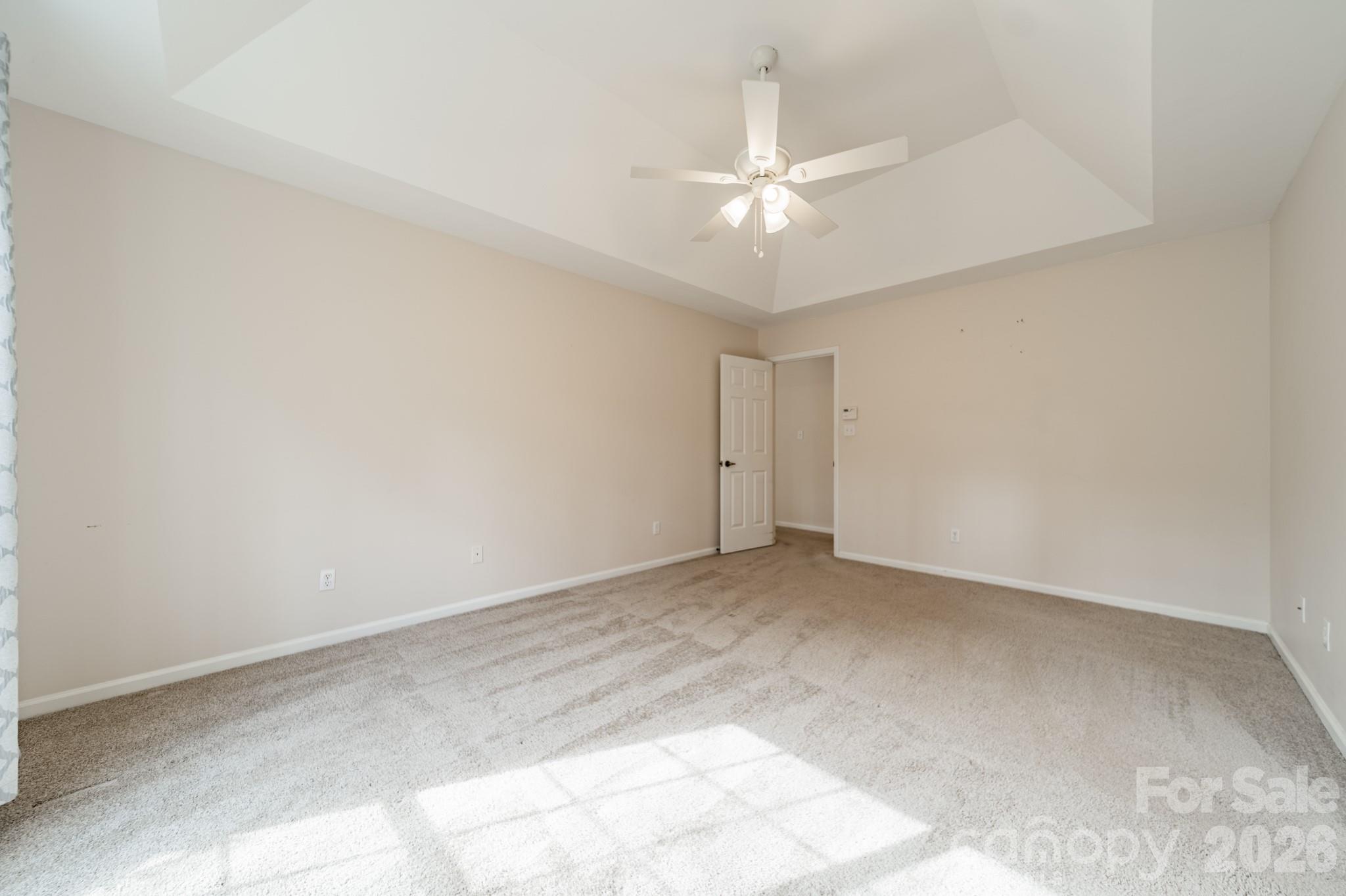 9409 Cedar River Road Huntersville, NC 28078 - Photo 27 of 31 an empty room with a chandelier fan and closet area