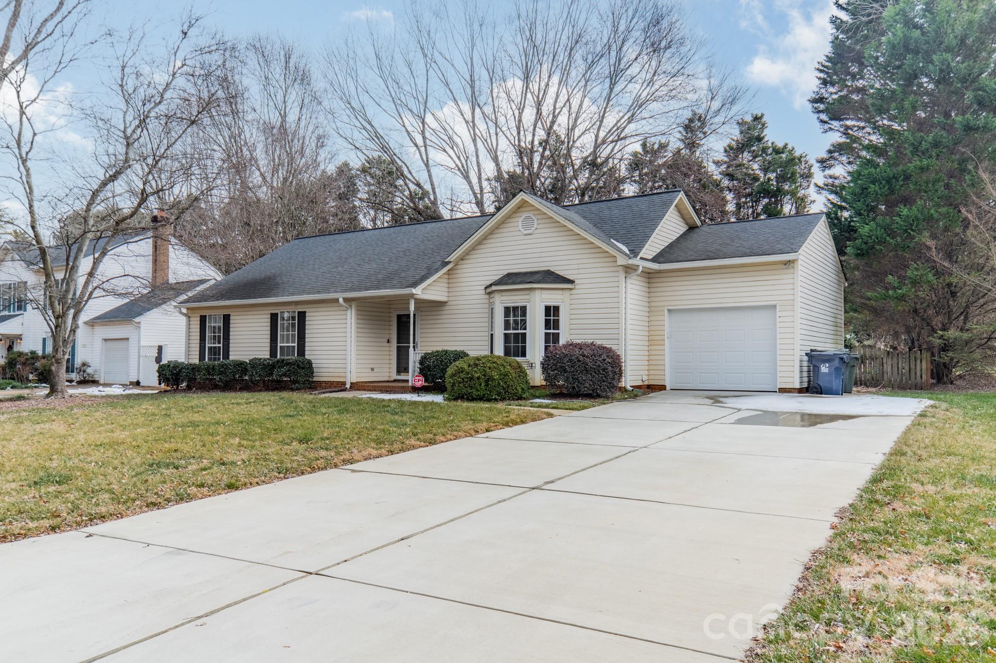 9409 Cedar River Road Huntersville, NC 28078 - Photo 7 of 31 a front view of a house with a yard and trees