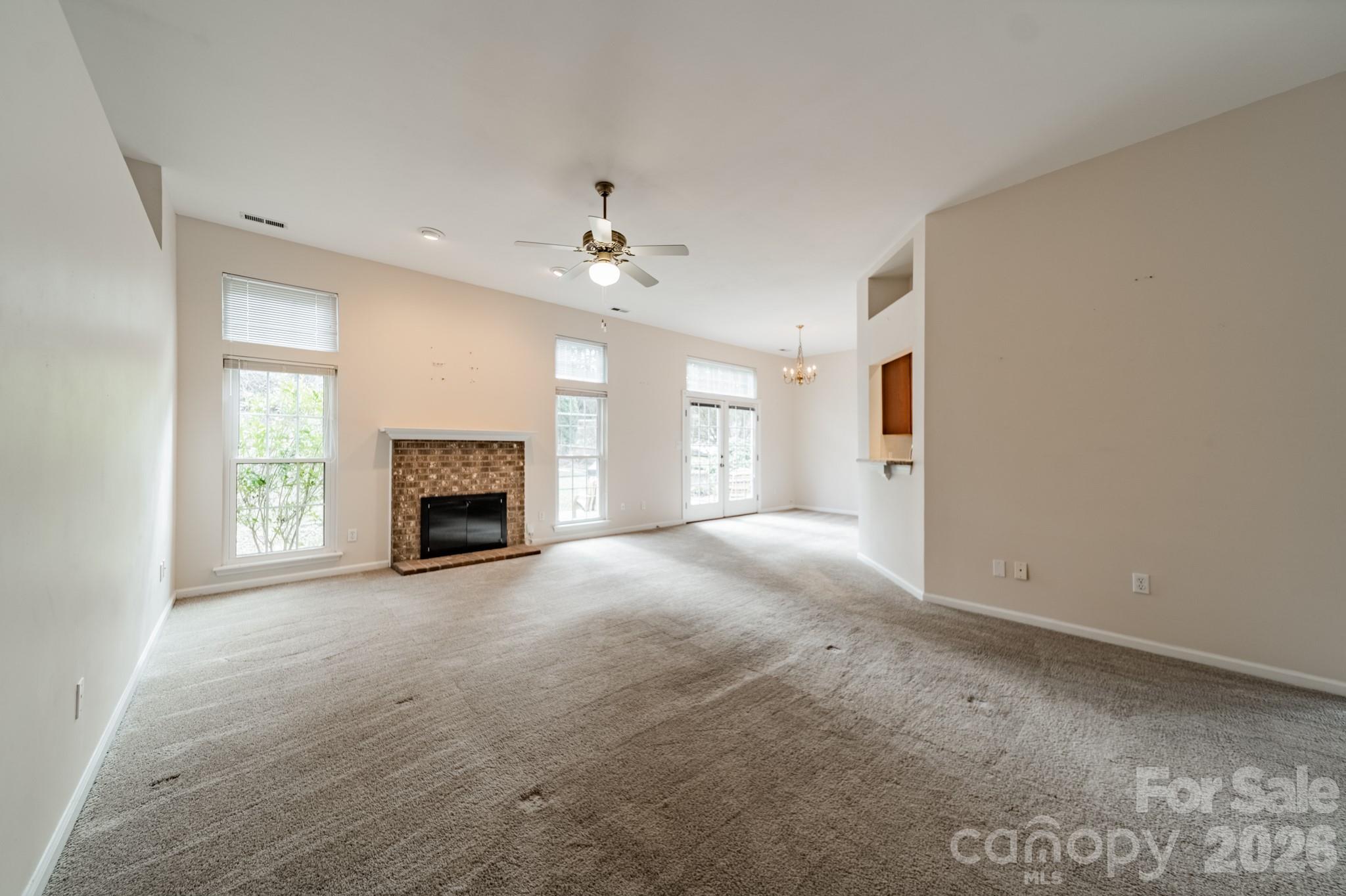 9409 Cedar River Road Huntersville, NC 28078 - Photo 9 of 31 an empty room with windows and fireplace