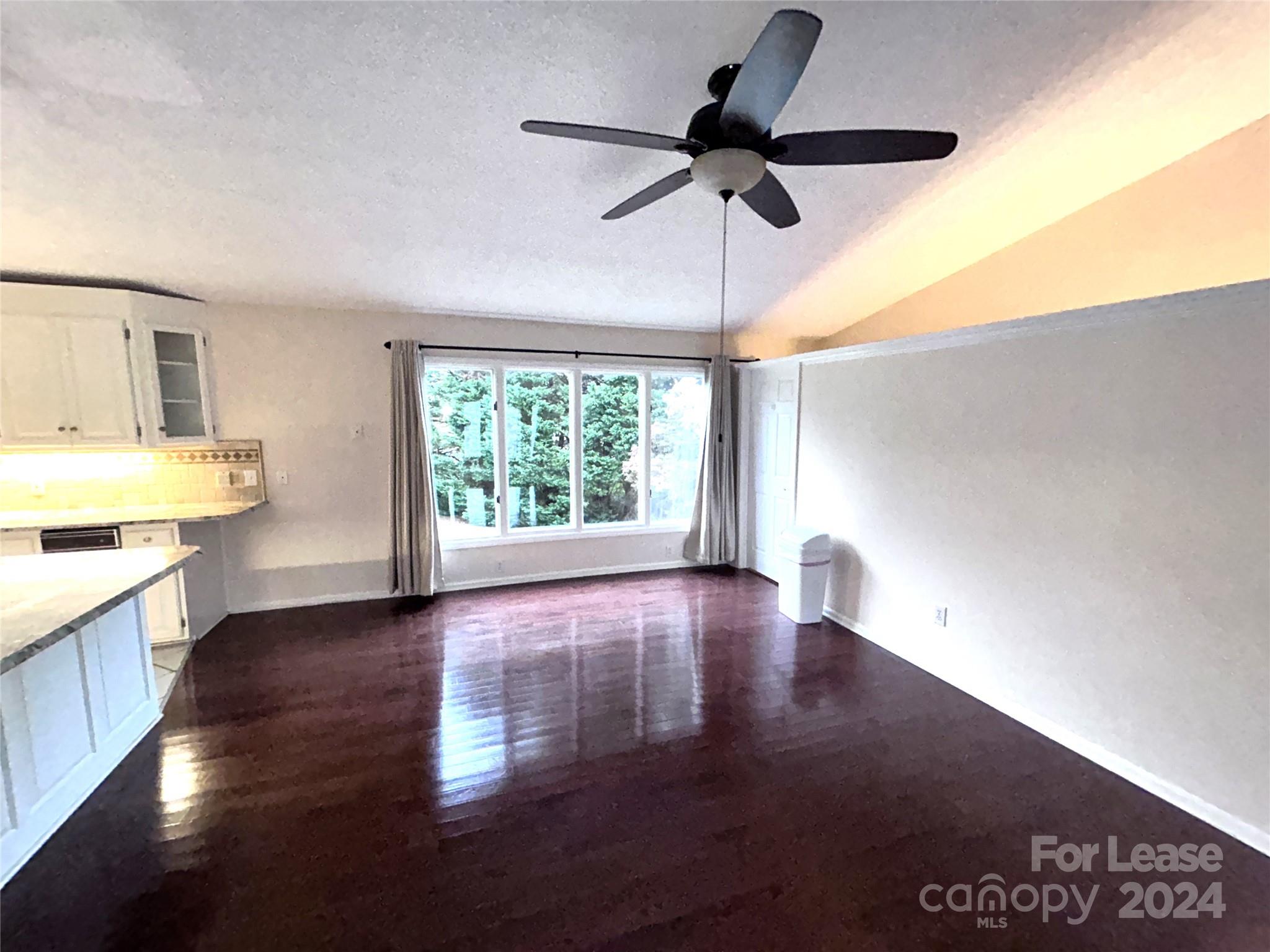 256 Spring Run Road Mooresville, NC 28117 - Photo 11 of 37 a view of an empty room with window and wooden floor
