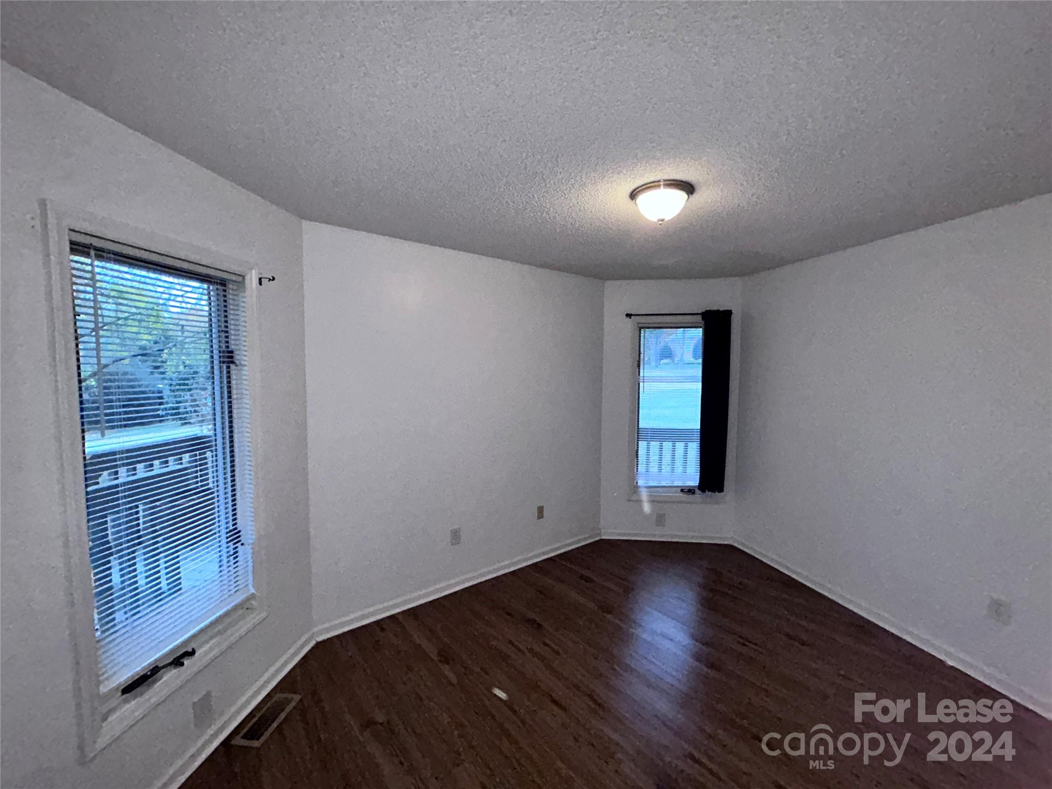 256 Spring Run Road Mooresville, NC 28117 - Photo 25 of 37 a view of an empty room with wooden floor and a window