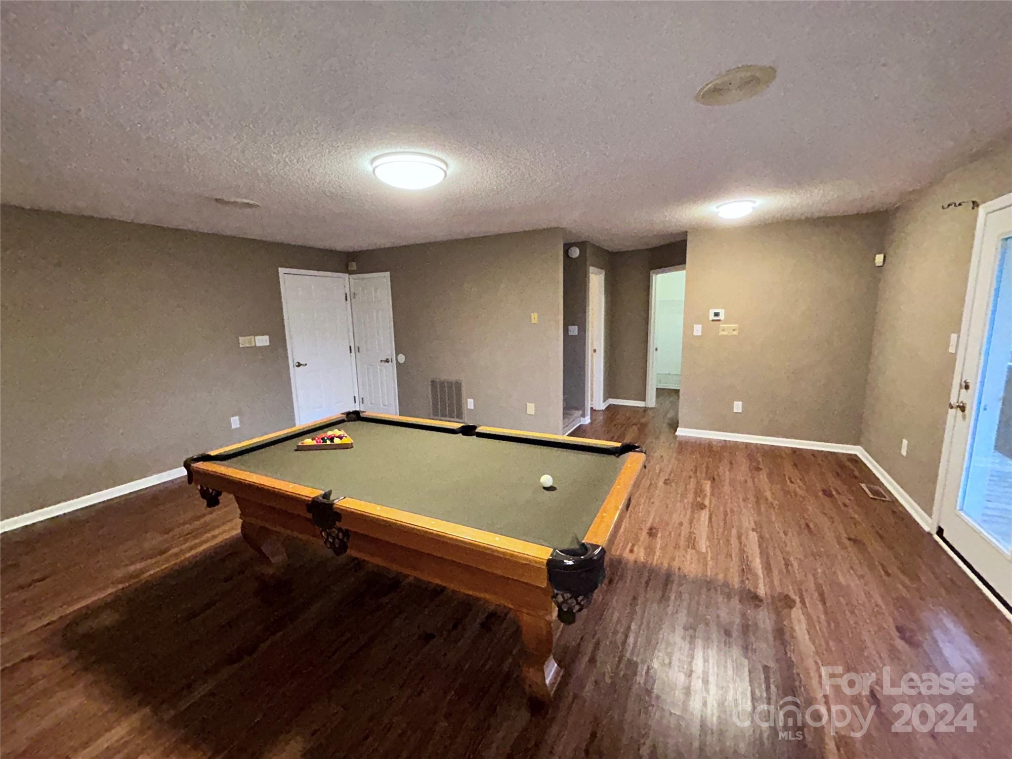 256 Spring Run Road Mooresville, NC 28117 - Photo 26 of 37 a room with wooden floor and pool table