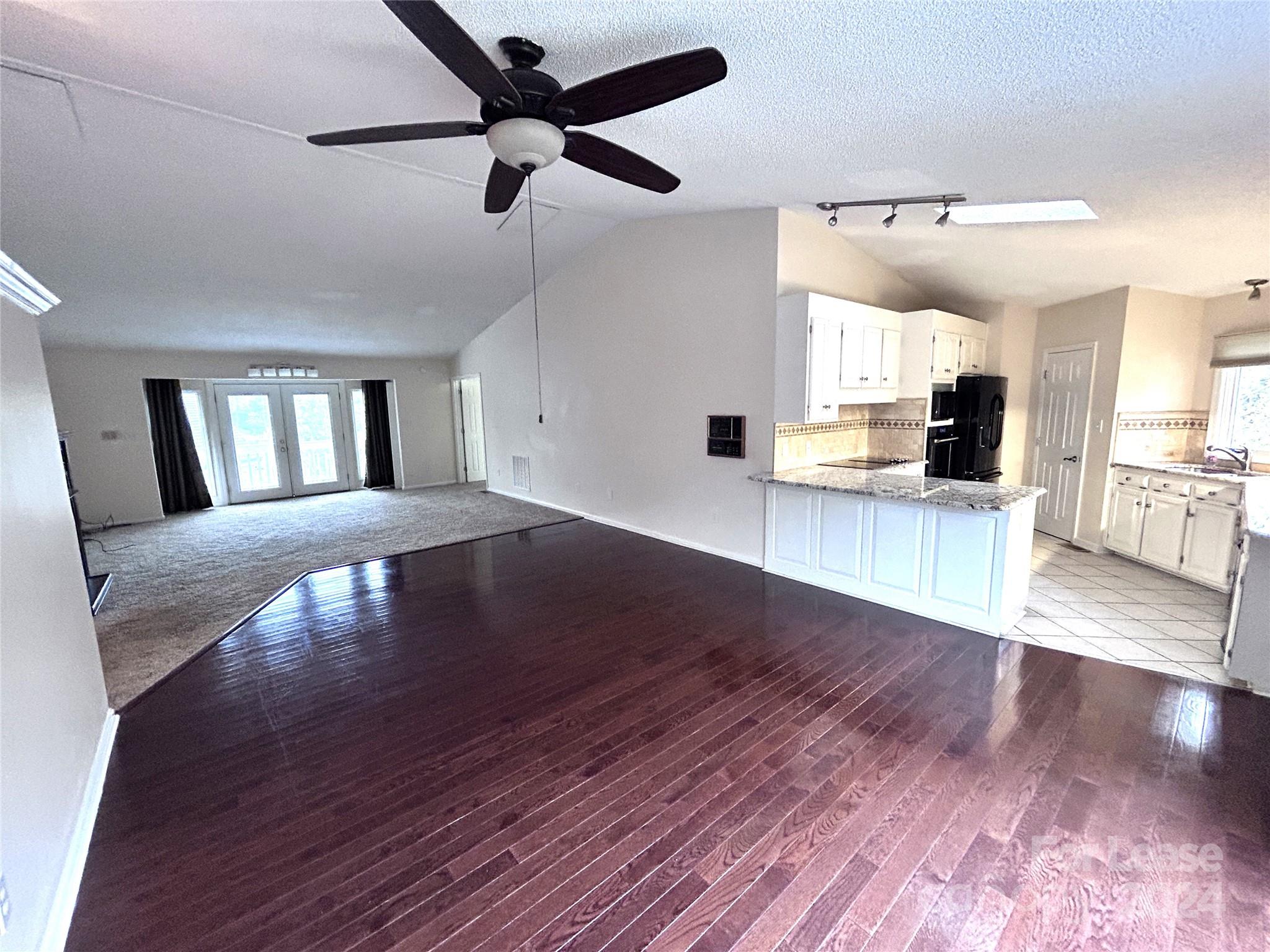 256 Spring Run Road Mooresville, NC 28117 - Photo 7 of 37 a view of a living room and kitchen with hardwood floor