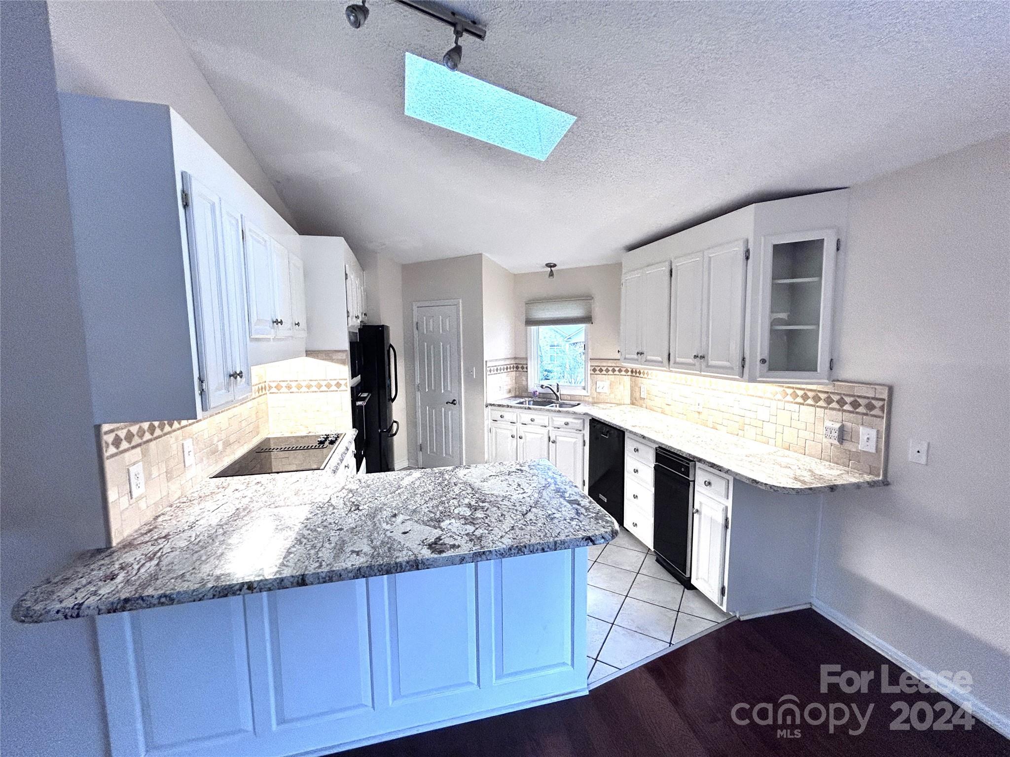 256 Spring Run Road Mooresville, NC 28117 - Photo 8 of 37 a large kitchen with granite countertop a stove and a sink