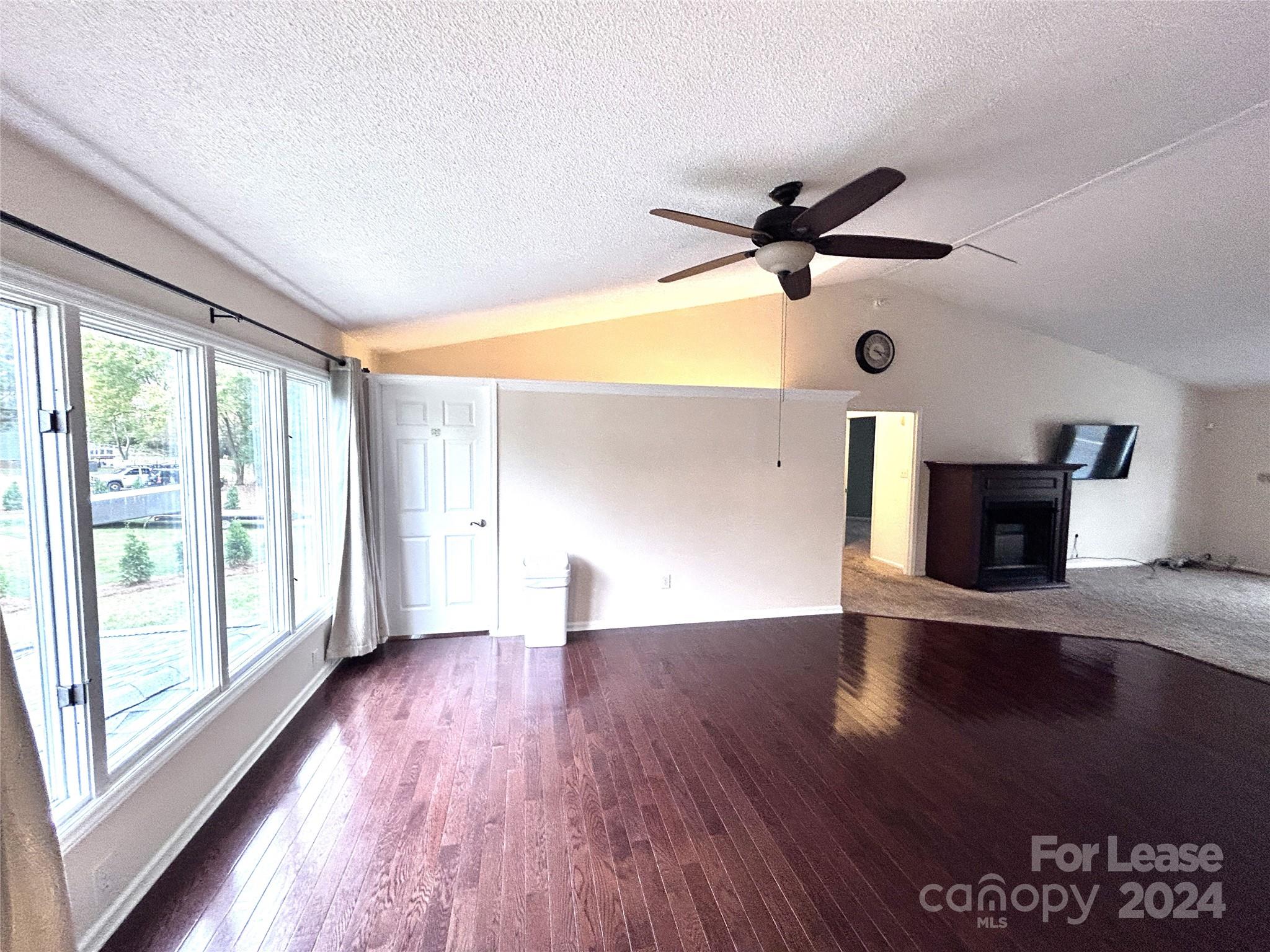 256 Spring Run Road Mooresville, NC 28117 - Photo 10 of 37 a view of empty room with wooden floor and fan