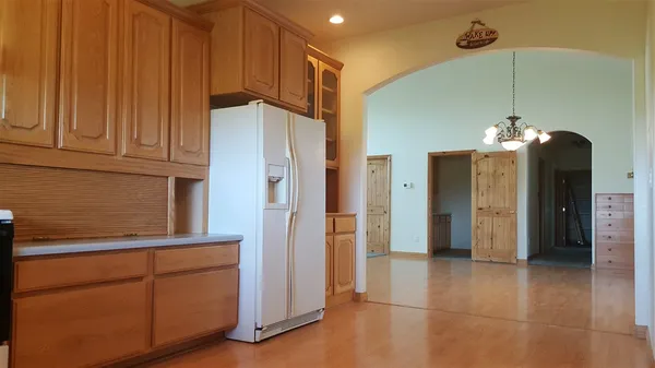 a kitchen with stainless steel appliances granite countertop a refrigerator and a sink