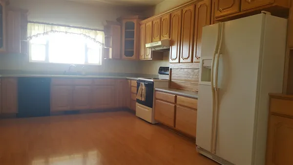 a kitchen with stainless steel appliances a refrigerator sink and cabinets
