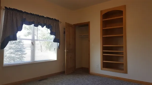 a bathroom with a window and a cabinet