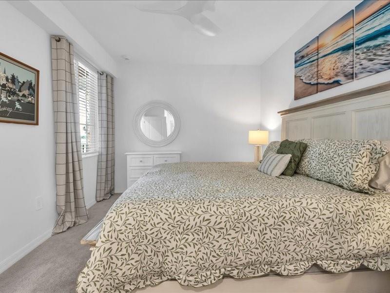 19116 Scallop Loop, Unit 303 Lakewood Ranch, FL 34211 - Photo 19 of 32 a bedroom with a bed and a painting on the wall