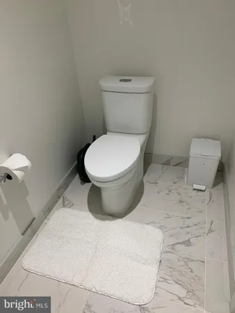 a white toilet sitting next to a bathroom sink