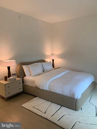 a bedroom with a bed and lamp