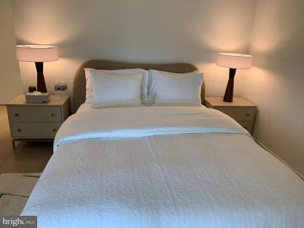 a bedroom with a bed and a lamp