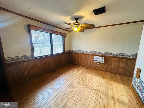 a view of a room with wooden floor and windows