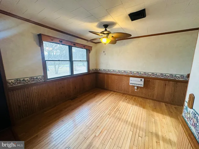 a view of a room with wooden floor and windows