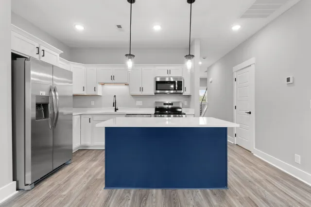 a large kitchen with stainless steel appliances kitchen island a large island in the center