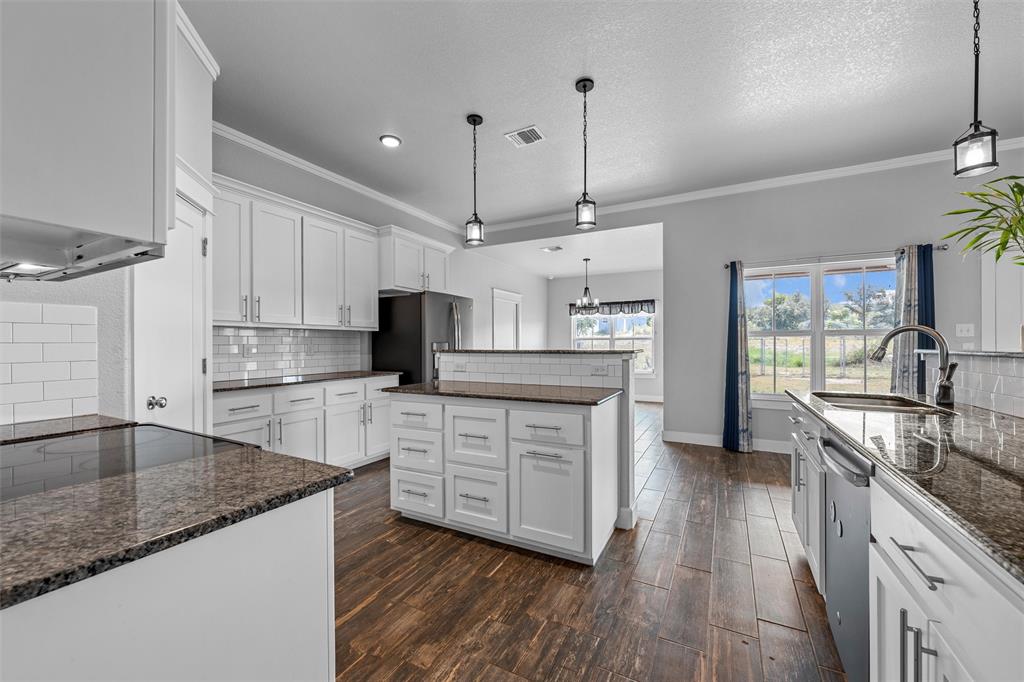 2662 Snow Road Kempner, TX 76539 - Photo 12 of 40 a kitchen with stainless steel appliances granite countertop a sink a stove and a wooden floors