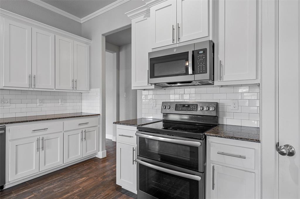 2662 Snow Road Kempner, TX 76539 - Photo 15 of 40 a kitchen with white cabinets and stainless steel appliances