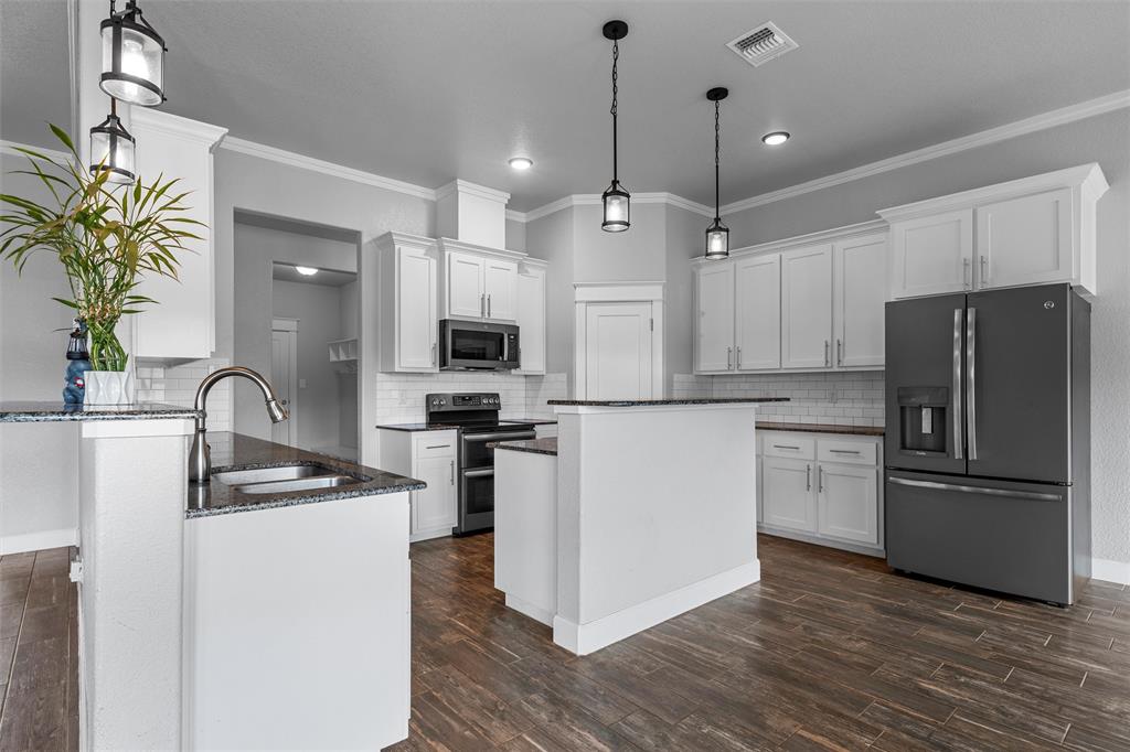 2662 Snow Road Kempner, TX 76539 - Photo 17 of 40 a kitchen with stainless steel appliances granite countertop a refrigerator a stove a sink dishwasher and a refrigerator with wooden floor