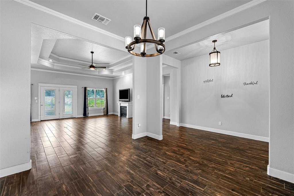 2662 Snow Road Kempner, TX 76539 - Photo 10 of 40 a view of an empty room with wooden floor and a ceiling fan