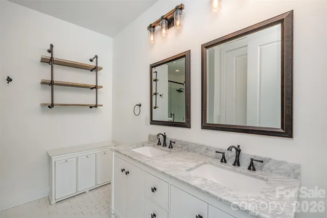 a bathroom with 2 sink and a mirror