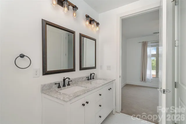 a bathroom with a granite countertop sink mirror and vanity