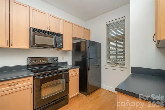 a kitchen with a refrigerator stove and microwave