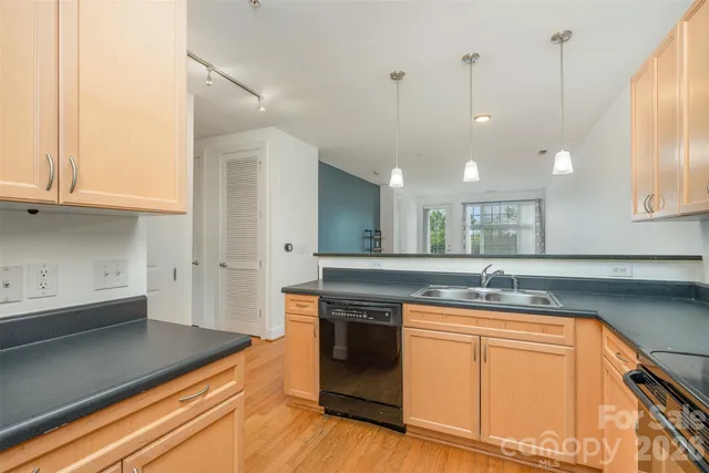 a kitchen with a sink cabinets and window