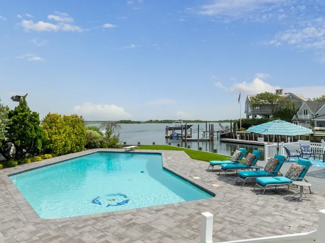 an outdoor space with swimming pool and furniture