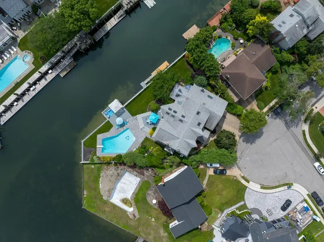 an aerial view of a house with a yard and lake view