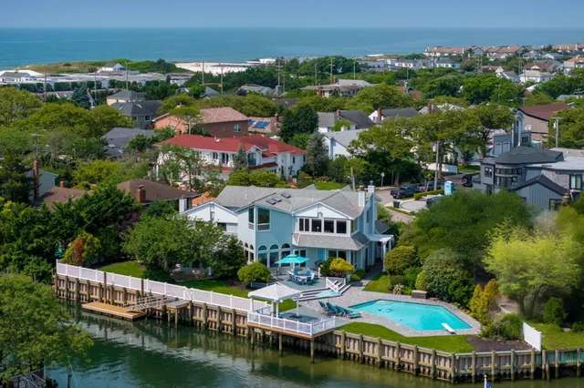 an aerial view of residential houses with outdoor space and swimming pool