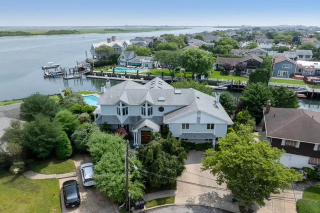 an aerial view of a house with outdoor space and lake view