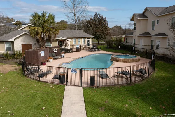 a view of a house with pool yard and sitting area