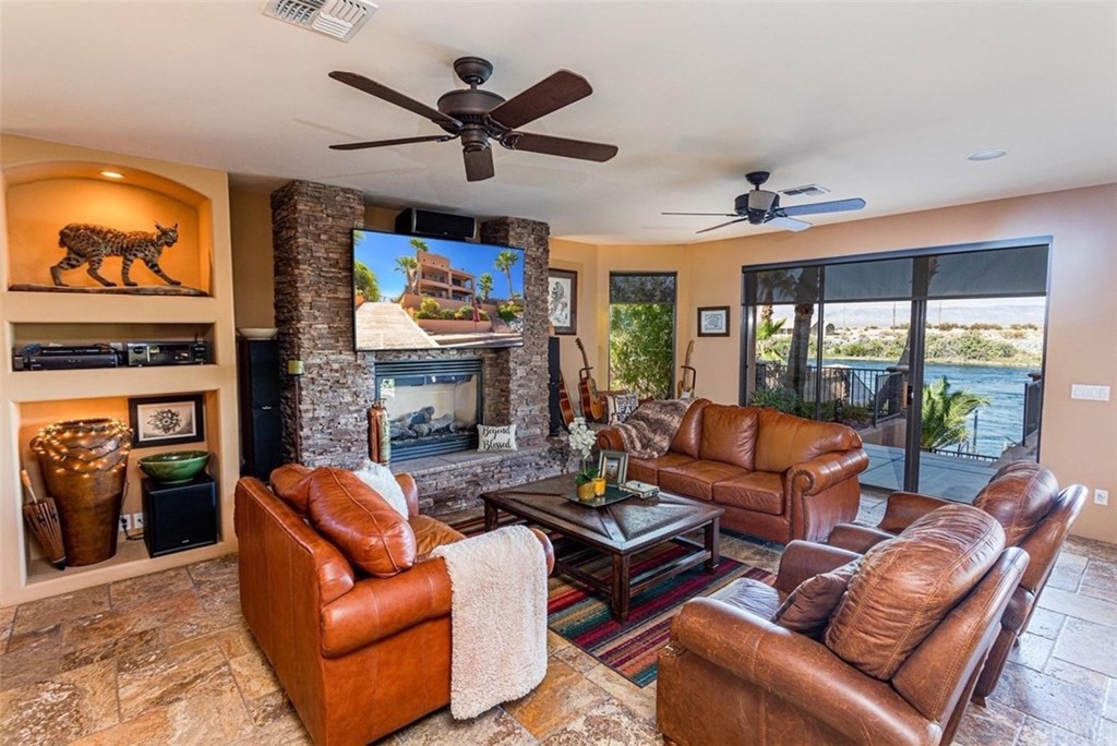 4654 My Place Road Needles, CA 92363 - Photo 12 of 75 a living room with fireplace furniture and a flat screen tv