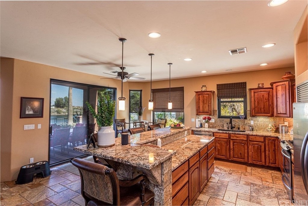 4654 My Place Road Needles, CA 92363 - Photo 14 of 75 Large Kitchen Featuring Beautiful Granite Counters, top of the line stainless steel appliances, Solid Knotty Alder Cabinetry, Custom Versailles Travertine Flooring which goes throughout, amazing views of the Colorado River.