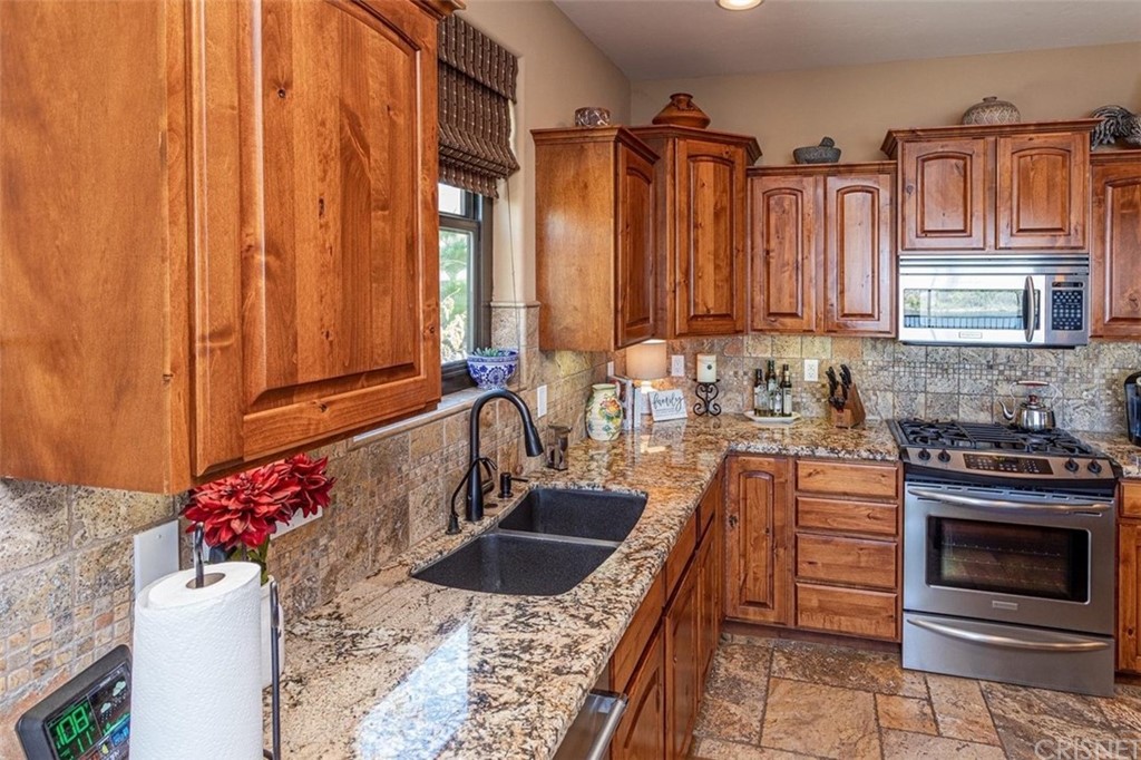 4654 My Place Road Needles, CA 92363 - Photo 15 of 75 a kitchen with granite countertop a sink stove and cabinets
