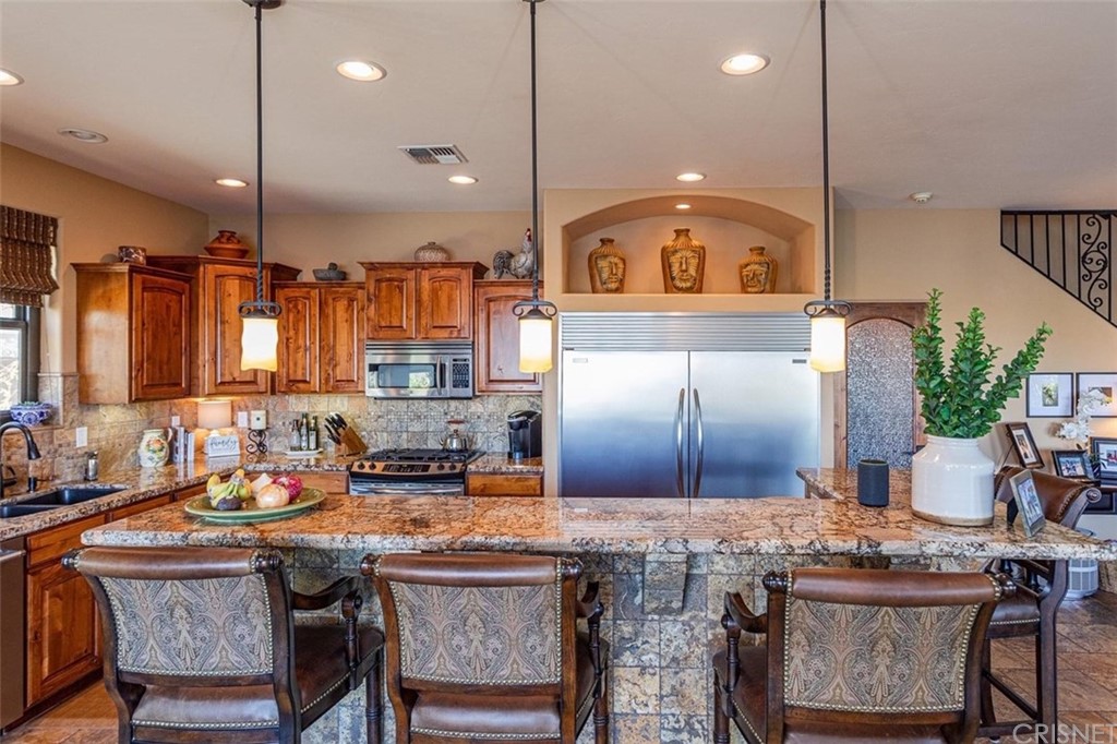 4654 My Place Road Needles, CA 92363 - Photo 19 of 75 a kitchen with a stove a sink and a refrigerator