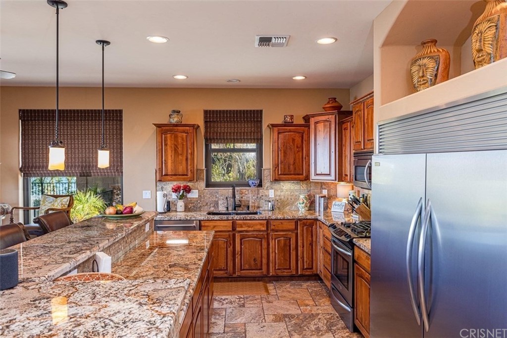 4654 My Place Road Needles, CA 92363 - Photo 20 of 75 a kitchen with stainless steel appliances granite countertop a sink a stove and a refrigerator