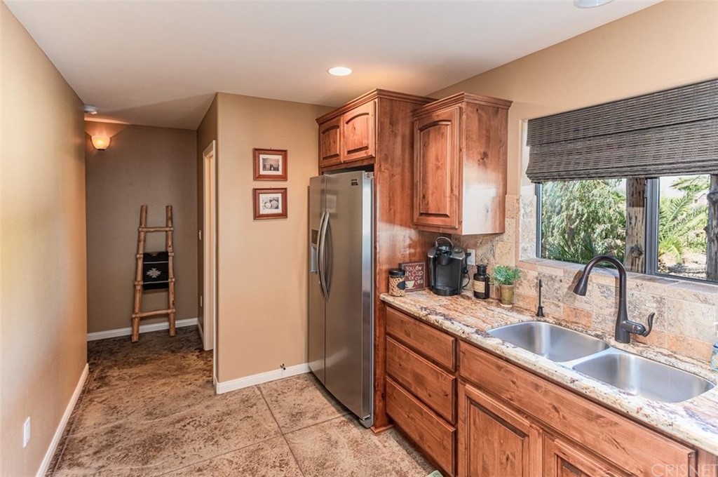 4654 My Place Road Needles, CA 92363 - Photo 53 of 75 a kitchen with stainless steel appliances granite countertop a refrigerator and a sink