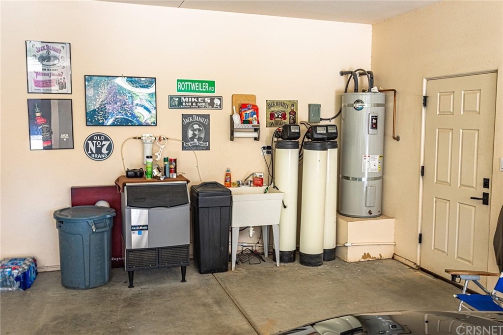 4654 My Place Road Needles, CA 92363 - Photo 57 of 75 Main house garage featuring water filtration system, RO system, and water softner with utility sink.