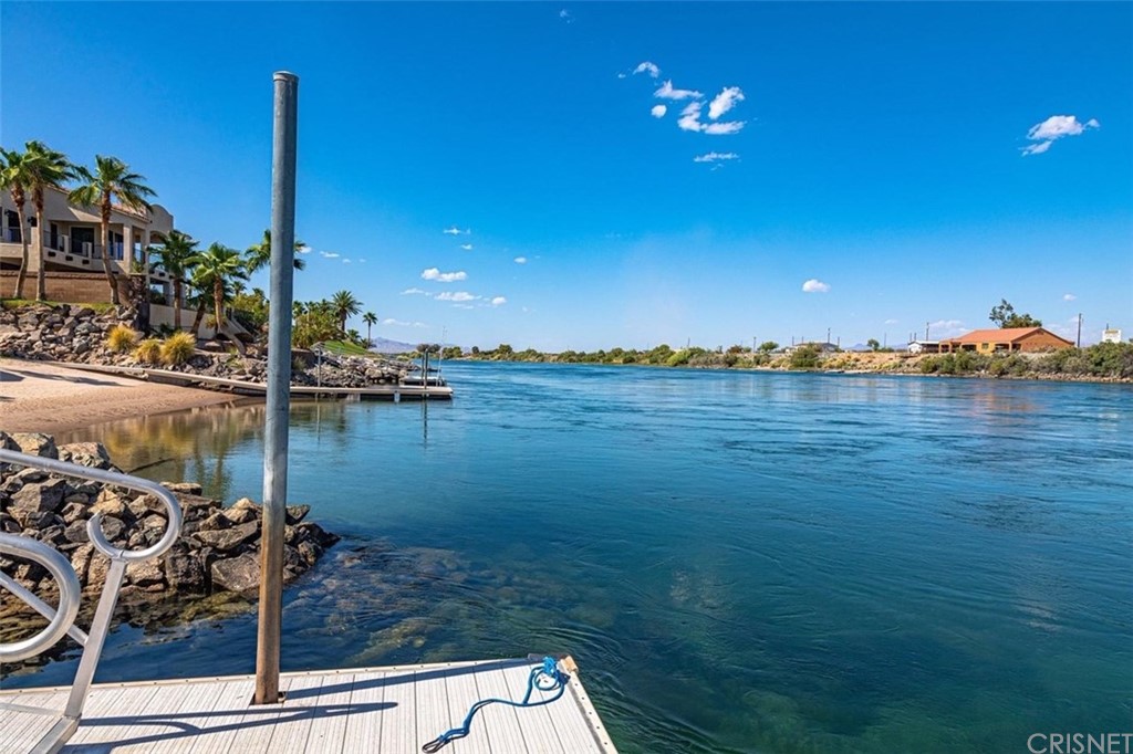 4654 My Place Road Needles, CA 92363 - Photo 70 of 75 a view of a lake with a palm tree next to a yard