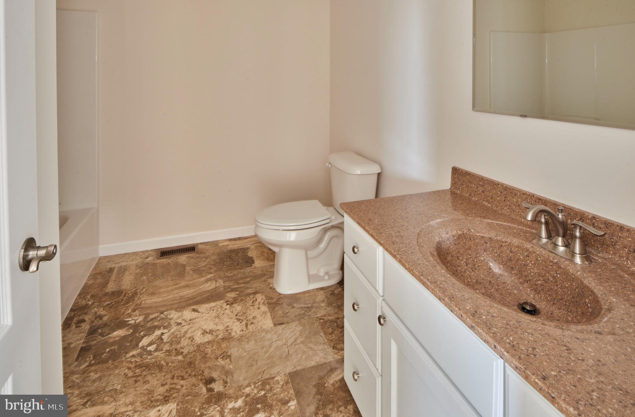 192 Timberwood Trail Centre Hall, PA 16828 - Photo 17 of 20 a bathroom with a granite countertop sink and a toilet