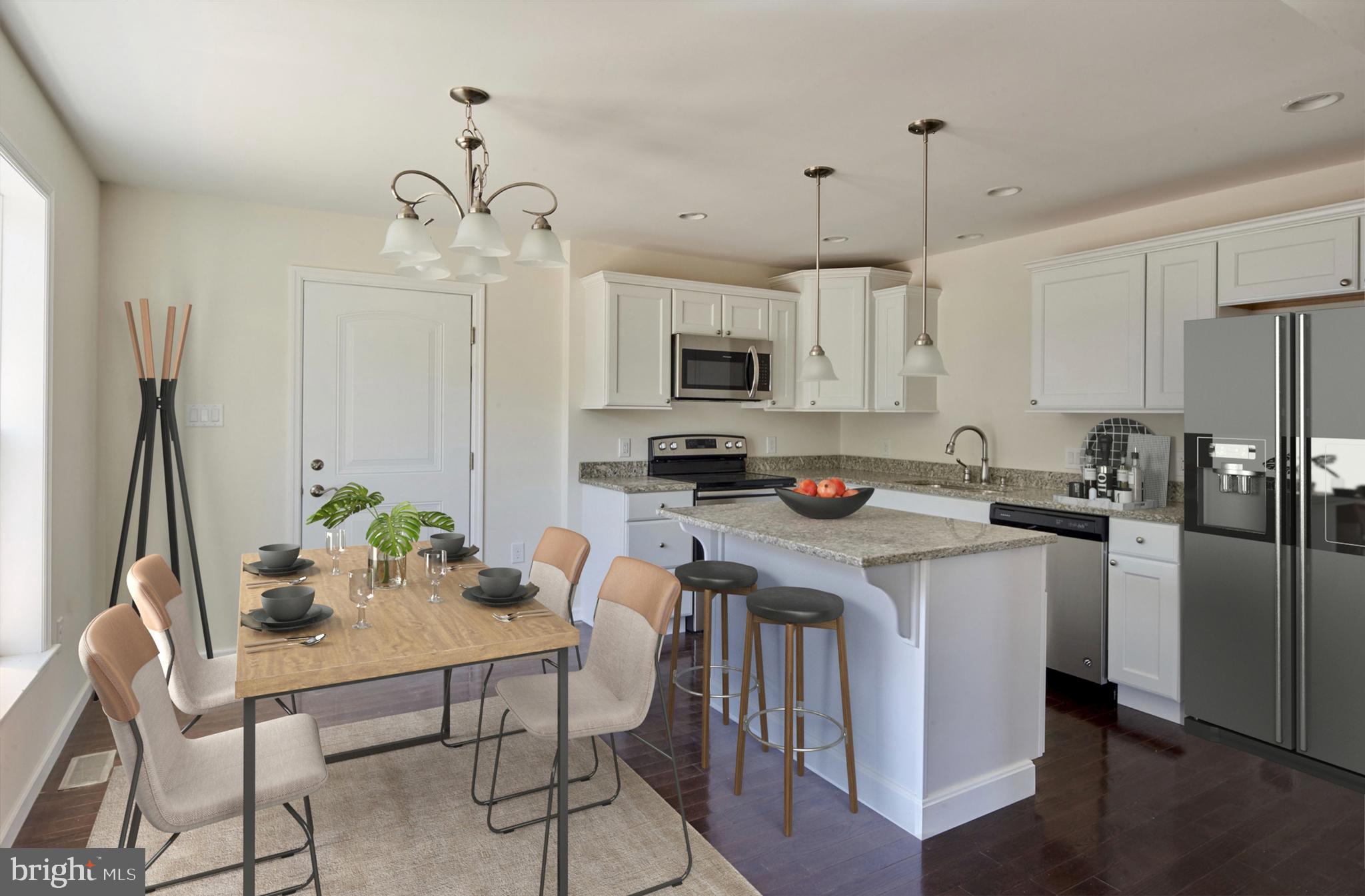 192 Timberwood Trail Centre Hall, PA 16828 - Photo 5 of 20 a kitchen with stainless steel appliances a table chairs refrigerator and microwave