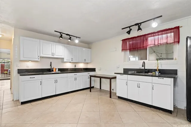 a kitchen with stainless steel appliances granite countertop a sink and a stove