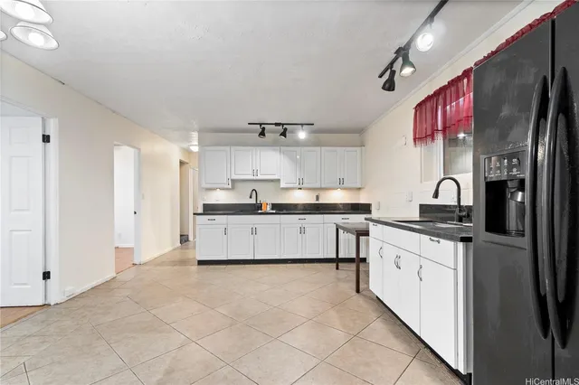 a kitchen with stainless steel appliances granite countertop a refrigerator sink and cabinets